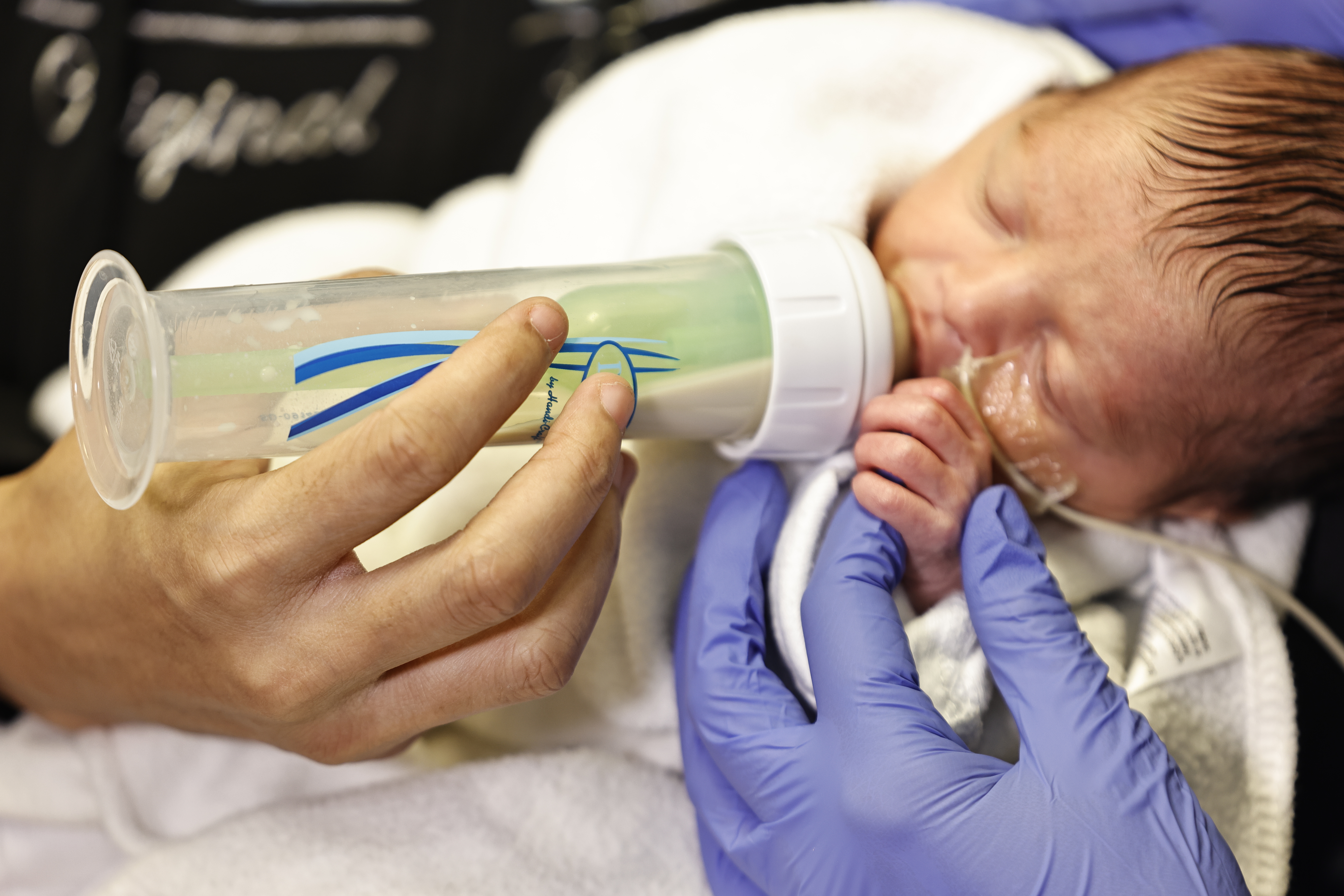 Mother holding newborn in UMC hospital room